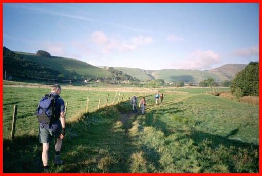 Mick, with Peter and Larry in front, enjoying the early morning sunshine as we walk across the fields from Hope towards Castleton.